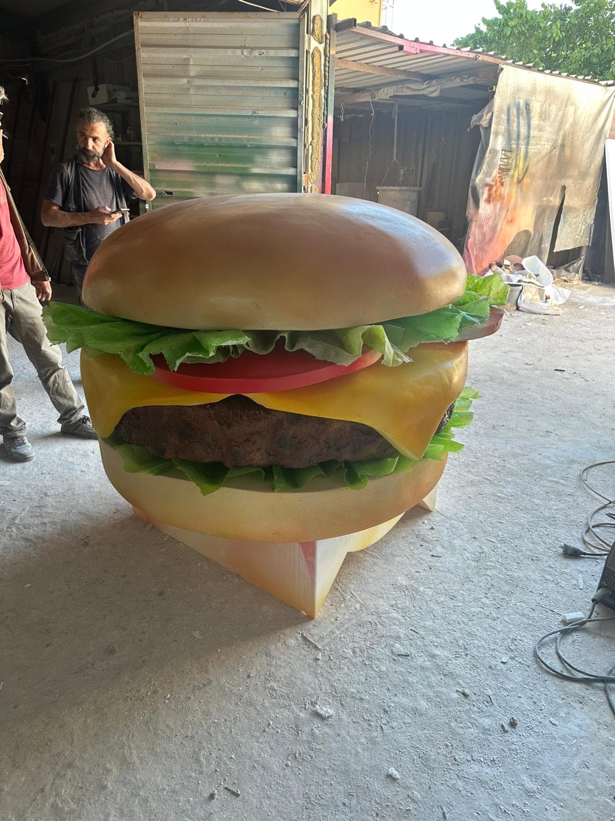 Oversized burger prop in workshop production for a commercial food display