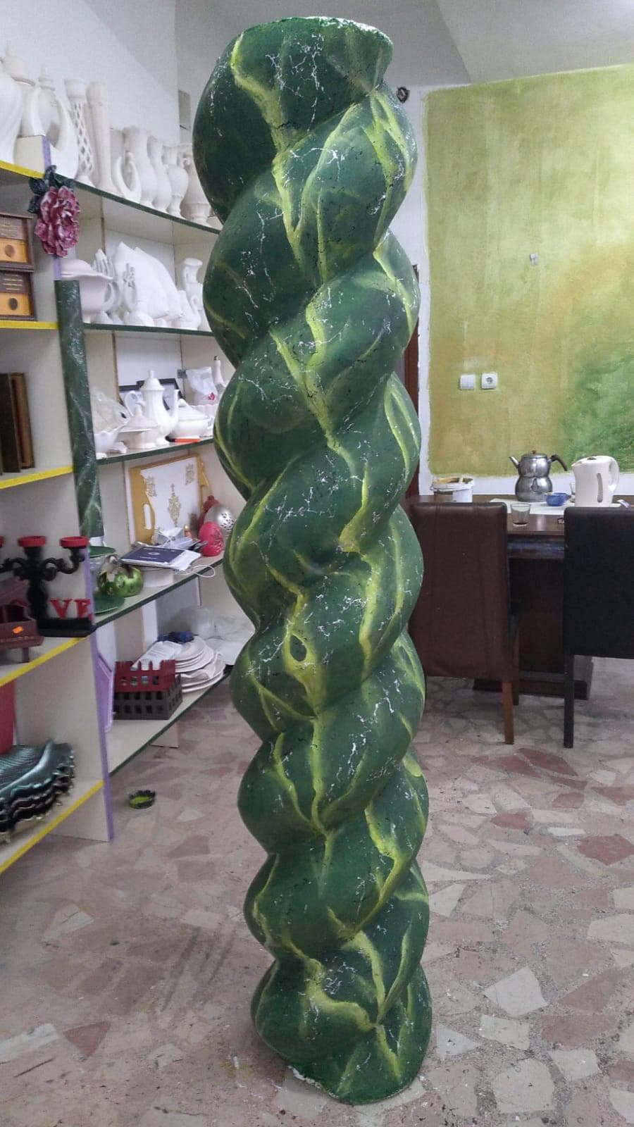 Green twisted decorative column form for a thematic architectural environment