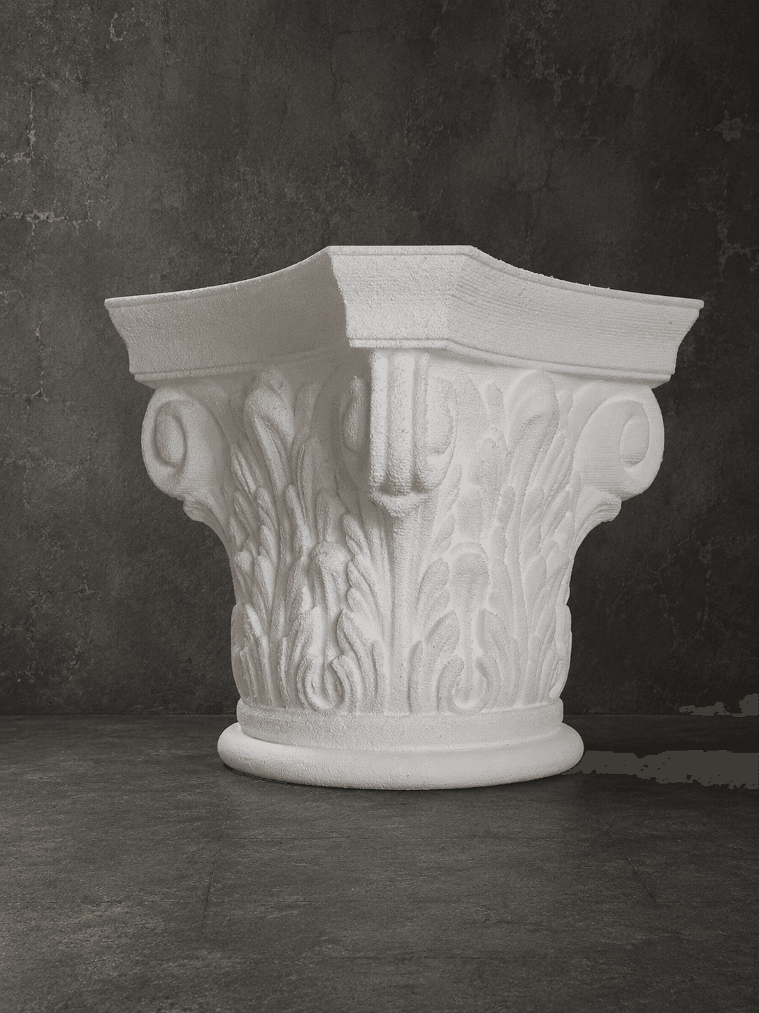 Decorative white column capital with classical leaf ornamentation